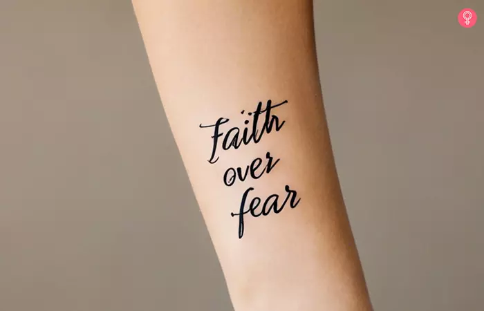 A faith over fear tattoo on the forearm