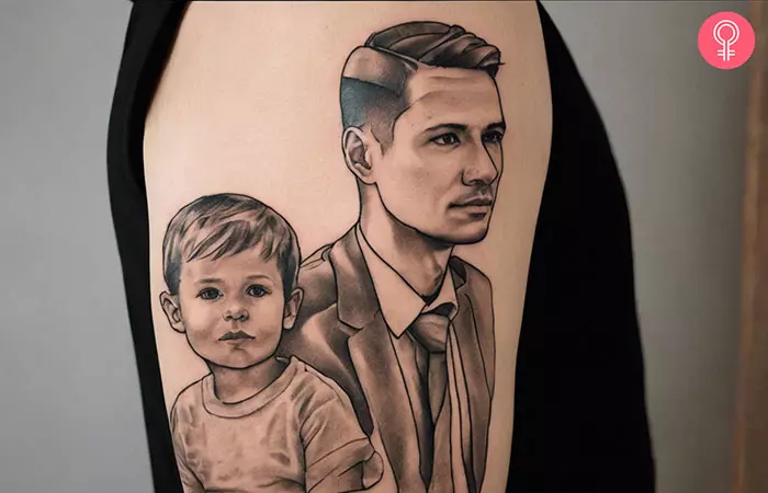 A father and son tattoo in black ink on the upper arm