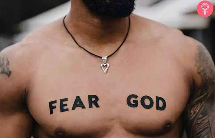 A man with a fear god tattoo on his chest 