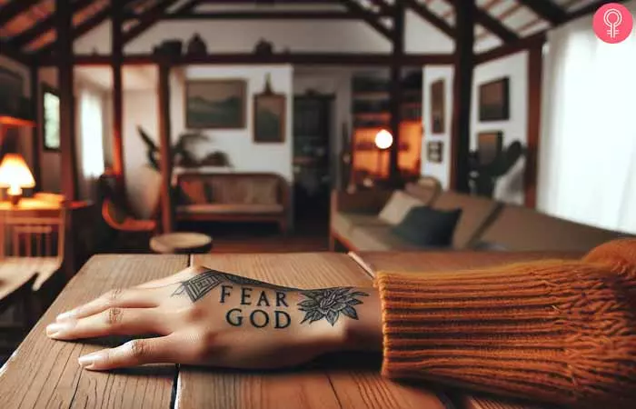 A woman with a fear god tattoo on her hand