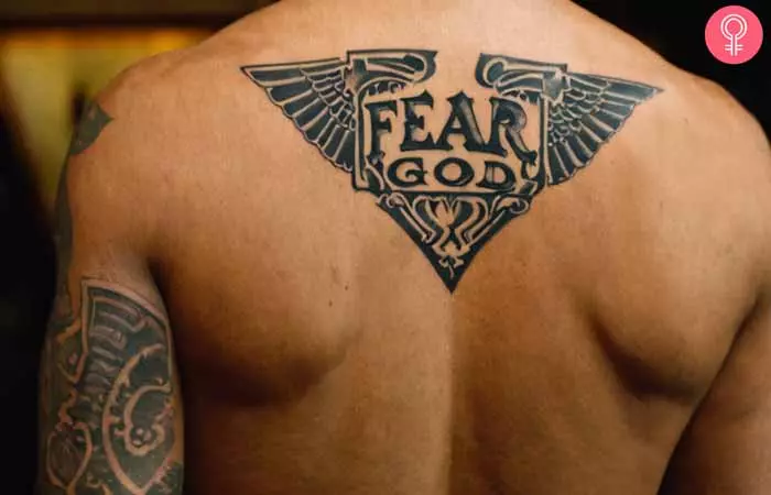 A man with a fear god tattoo on his shoulder