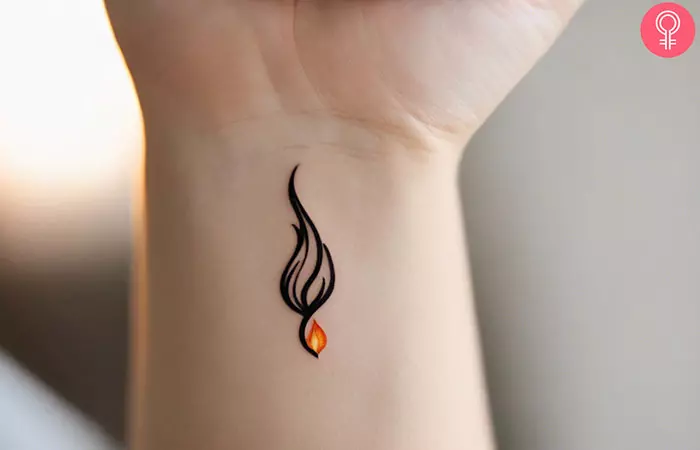 Woman with feminine small flame tattoo on her wrist