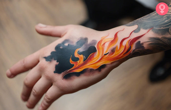 A fire tattoo design on the back of the hand of a man