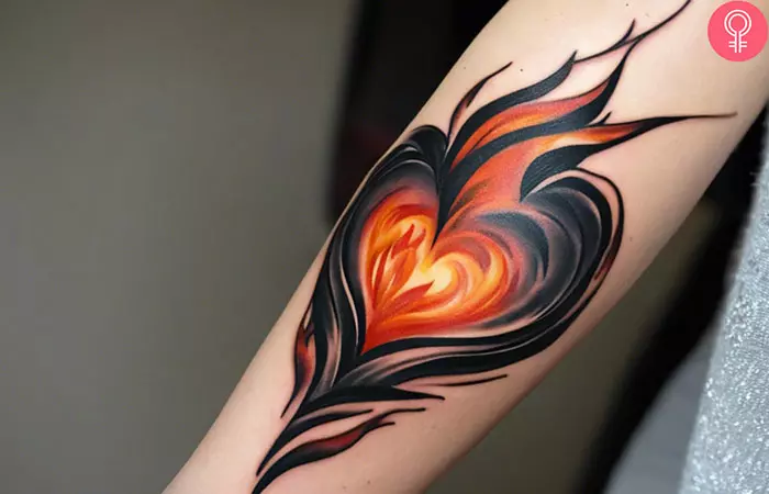 Woman with flame heart tattoo on her forearm