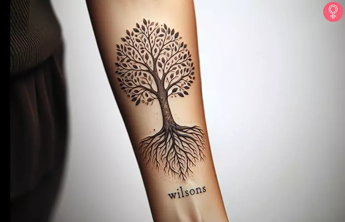 A family tree forearm tattoo on a woman