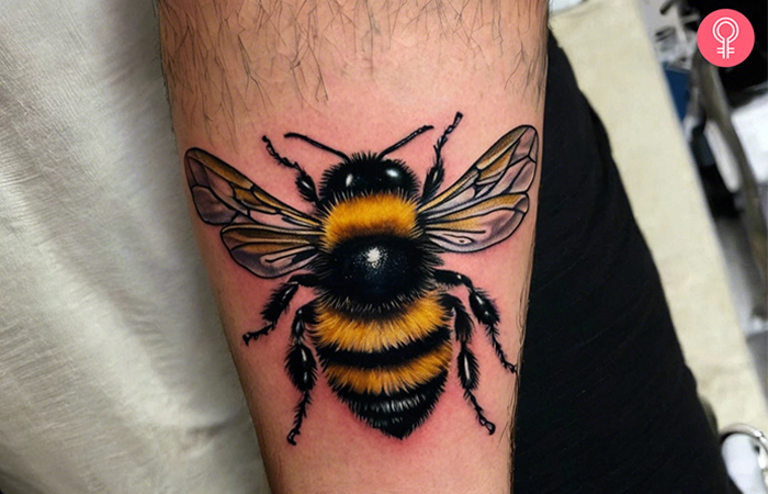 A fuzzy and realistic bumble bee tattoo on the forearm