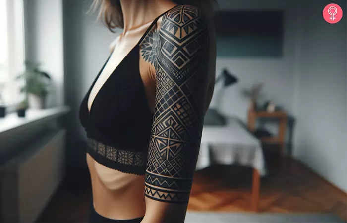 A geometric blackout tattoo on the upper arm