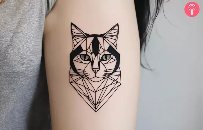 A woman with a geometric cat tattoo on her arm