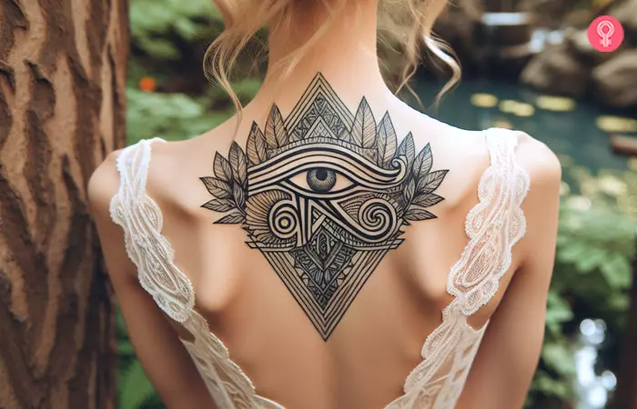 A geometric eye of Horus tattoo design on the upper back