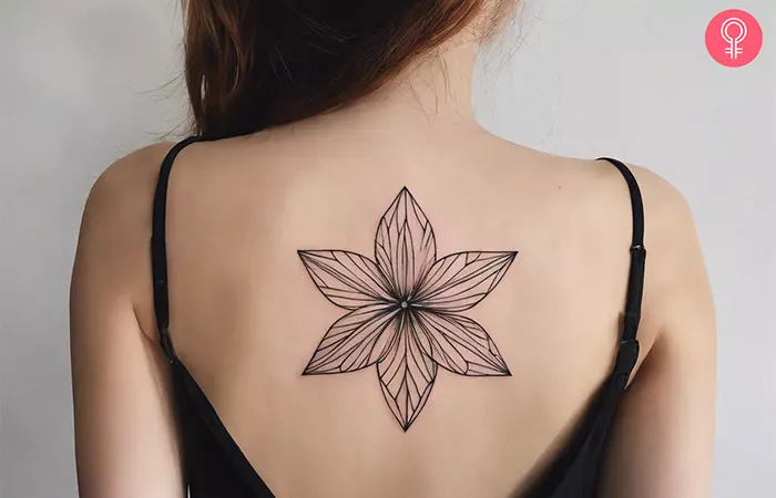 A woman with a geometric flower tattoo on her back