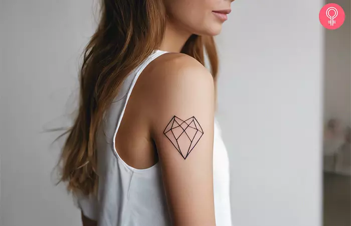 A woman with a geometric heart design on her upper arm