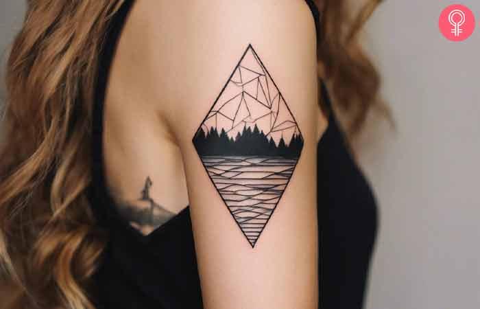 A woman with a geometric landscape tattoo on her upper arm