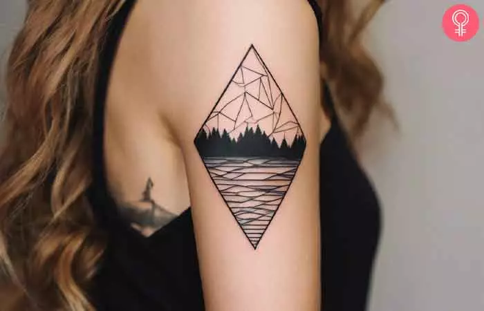 A woman with a geometric landscape tattoo on her upper arm