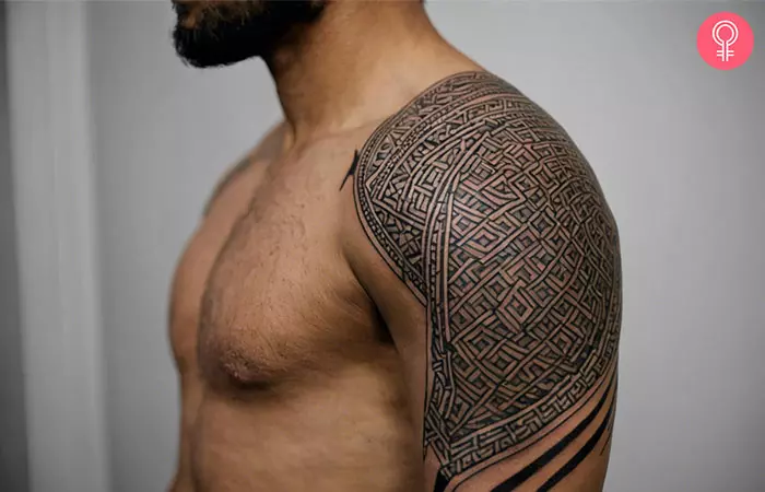 A man sporting a geometric quarter sleeve tattoo on his upper arm