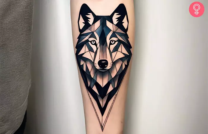 A man with a geometric wolf tattoo on his arm