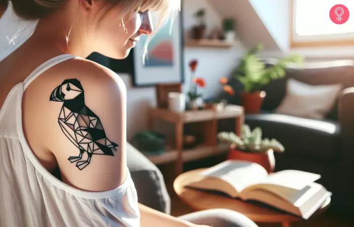 Geometric puffin tattoo on a woman’s shoulder