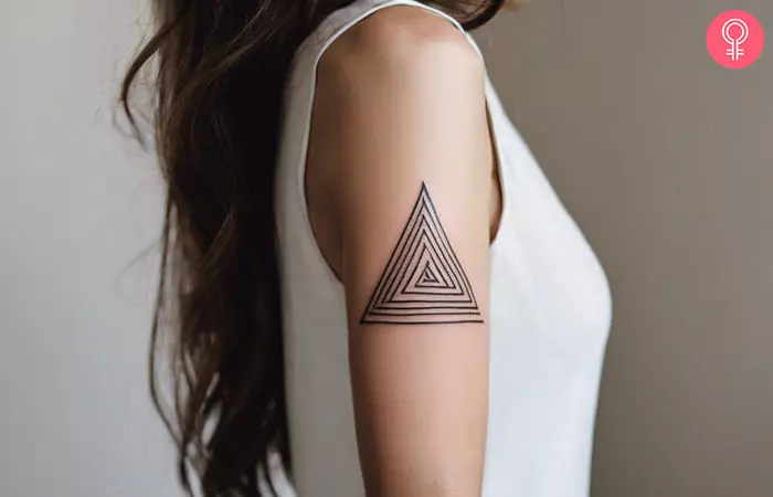 Geometric spiral tattoo on the upper arm