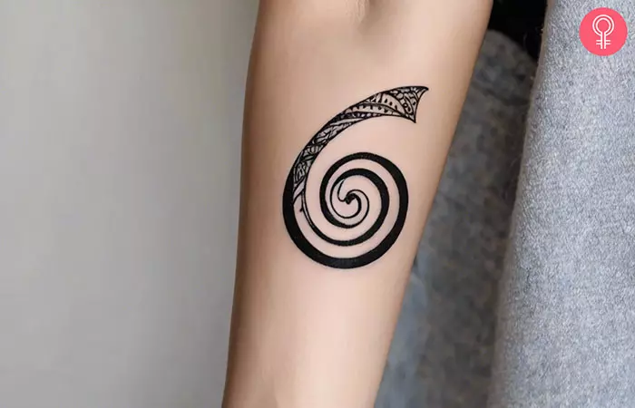 Golden spiral tattoo on the upper arm