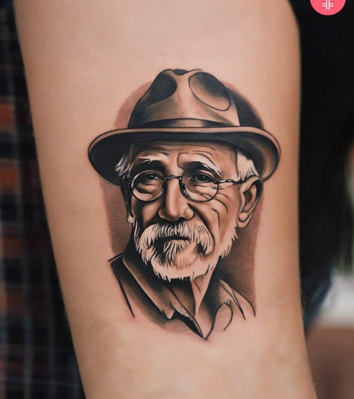 8 Heartfelt Grandpa Tattoo Ideas To Honor His Legacy A grandpa portrait tattoo on a woman’s thigh