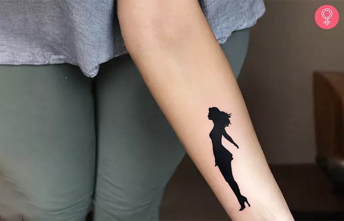 A woman’s silhouette growth tattoo on the forearm