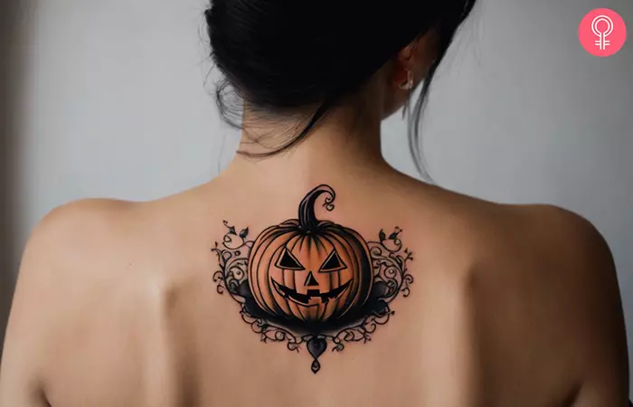 Halloween pumpkin tattoo on the upper back