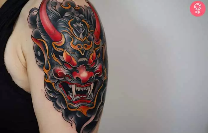  A woman with a Hannya Oni mask tattoo on her upper arm