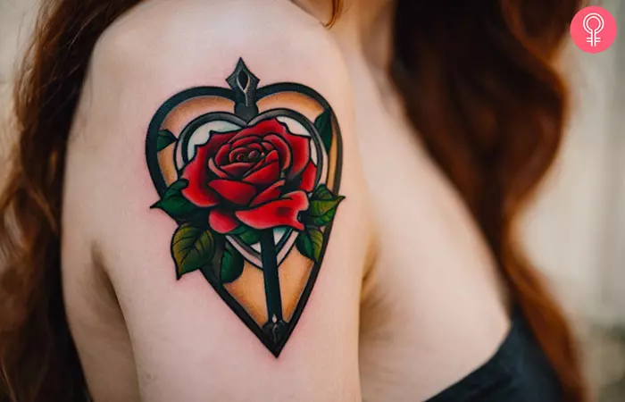Heart planchette tattoo with a rose on the upper arm