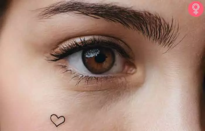Heart under eye tattoo