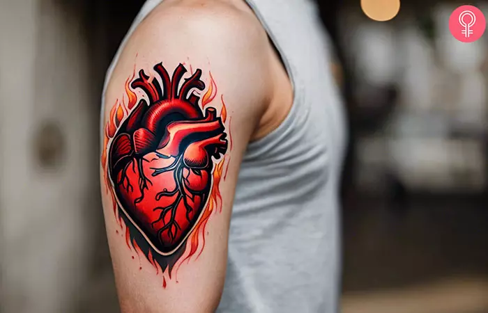 A man with heart with flames tattoo on his upper arm