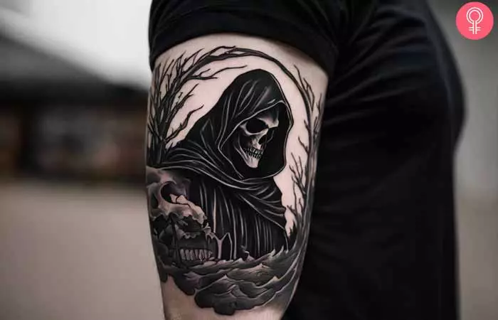 A man with a bold grim reaper blackwork tattoo design on his bicep 