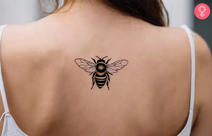 A woman with a honey bee tattoo on her nape