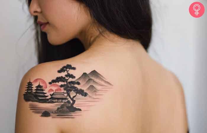 A woman with a Japanese landscape tattoo on her back shoulder