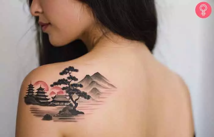 A woman with a Japanese landscape tattoo on her back shoulder