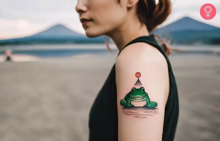 Japanese frog tattoo on a woman’s upper arm