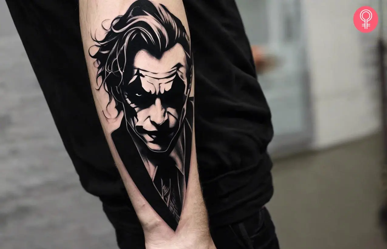 Joker face tattoo on a man’s forearm