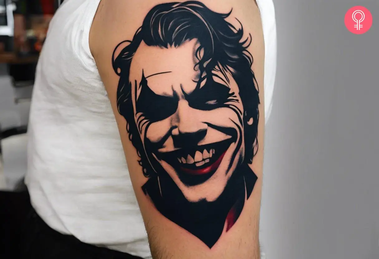 Joker smile tattoo on the arm