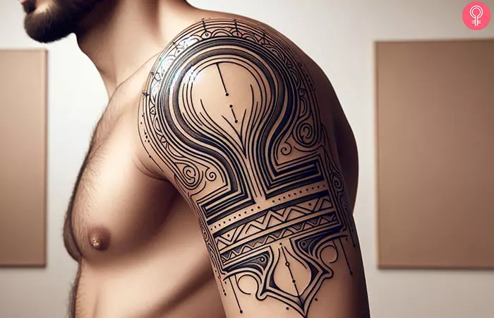 A man with a Libra glyph tattoo on his upper arm