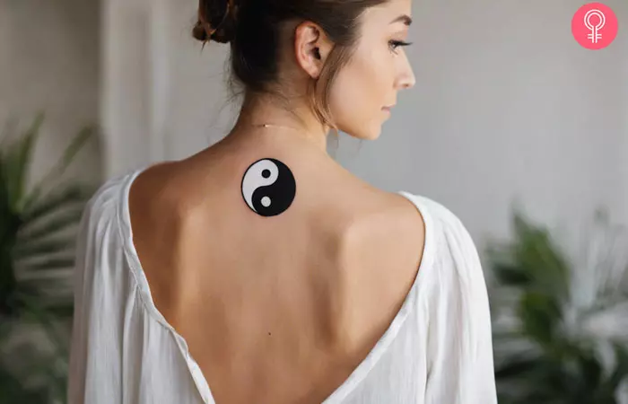 A life and death yin-yang tattoo on a woman’s back