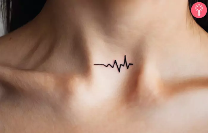 A woman wearing a heartbeat tattoo on her neck