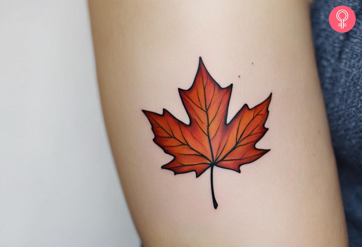 A woman with a maple leaf tattoo on her knuckle