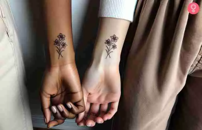 Matching friendship flower tattoos on the wrist