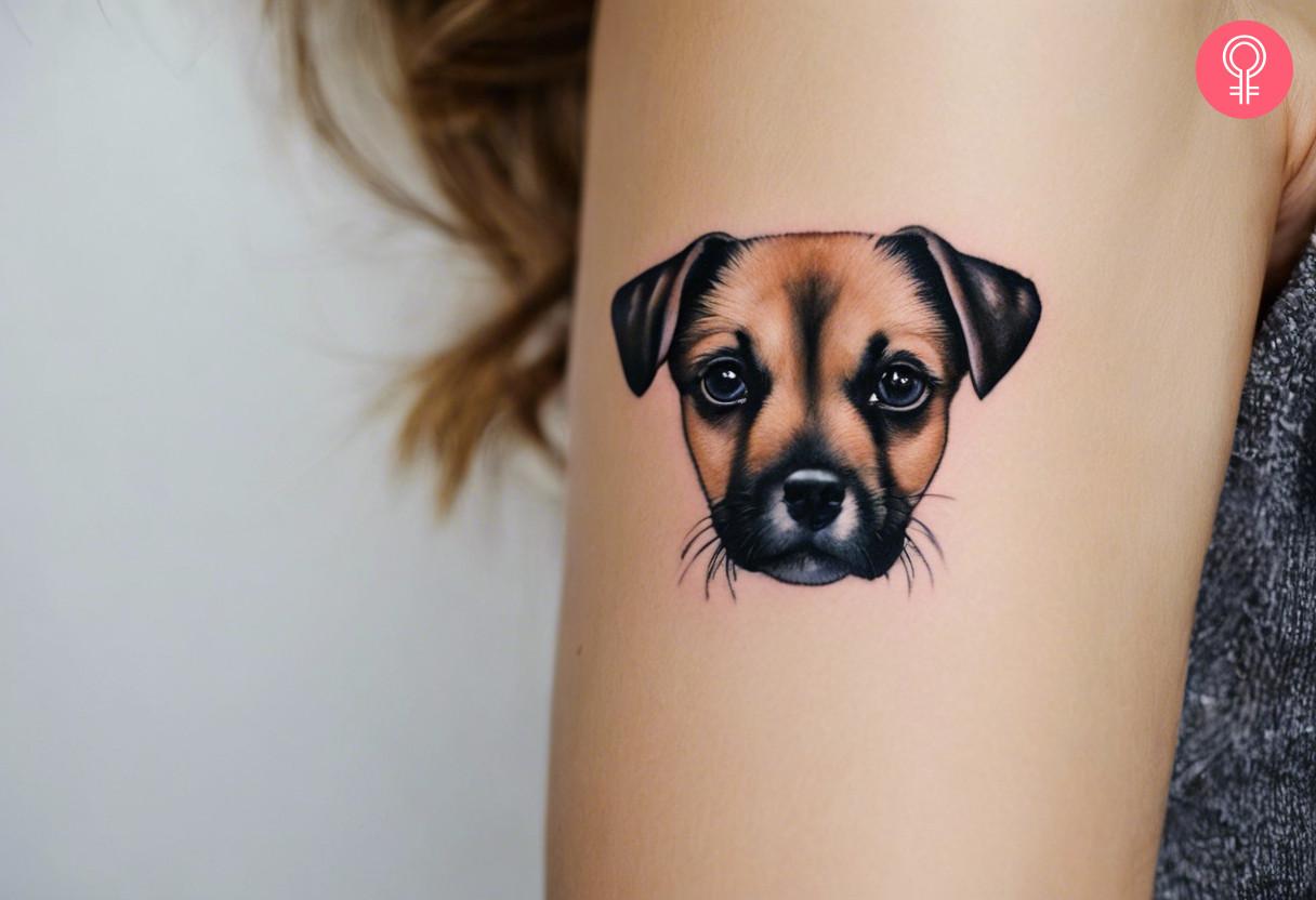 Microrealistic dog tattoo on a woman's upper arm