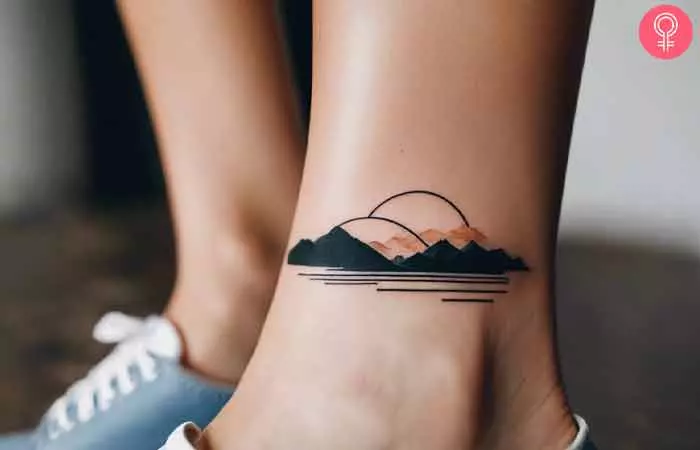 A woman with a minimalist landscape tattoo on her ankle