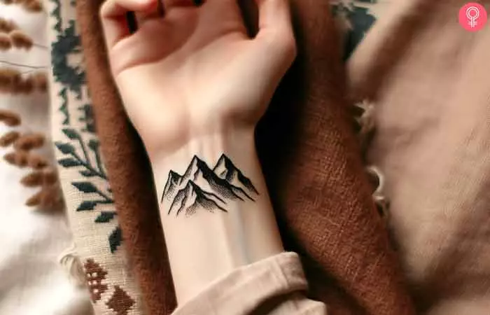 A woman with a mountain landscape tattoo on her wrist