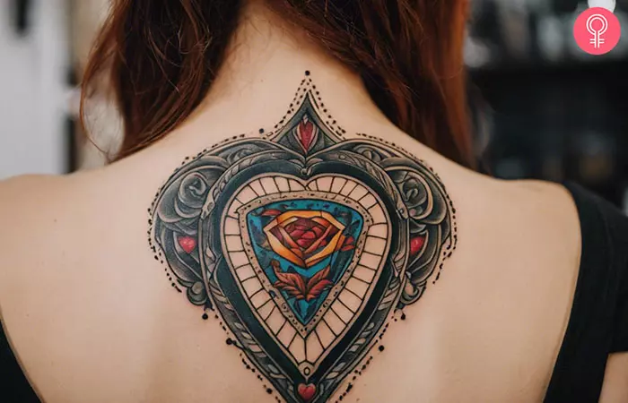 A neo-traditional planchette tattoo on a woman’s back