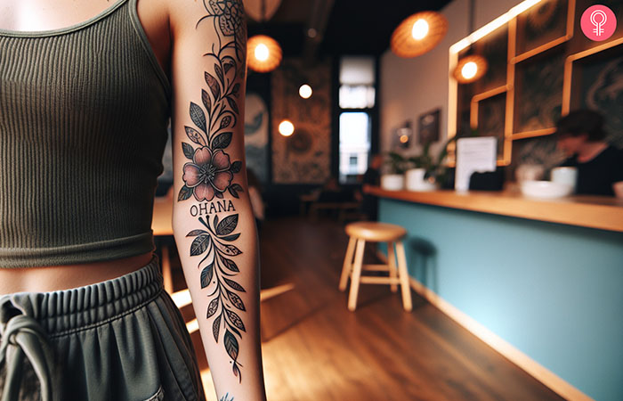 On ohana and flower tattoo design on the arm of a woman
