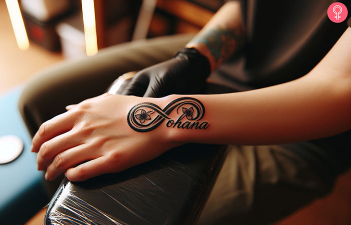 Ohana tattoo infinity design on the hand of a woman