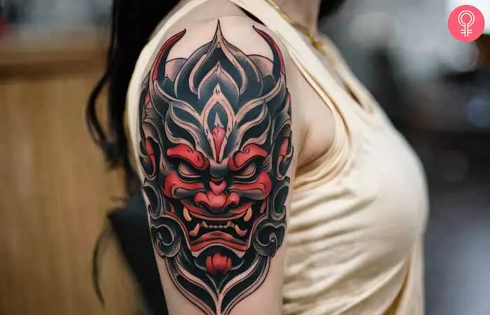 A woman with an Oni demon tattoo on her upper arm