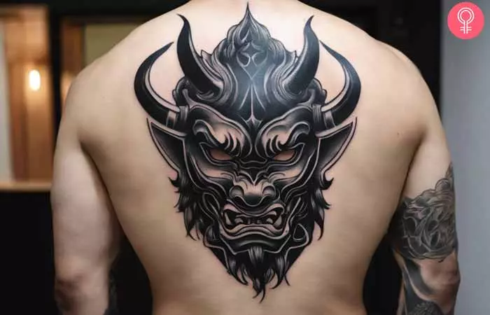  A man with a Oni mascara tattoo on his back