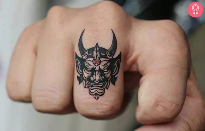 A man with an Oni Mask hand tattoo